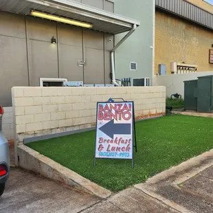 a sign in front of a building