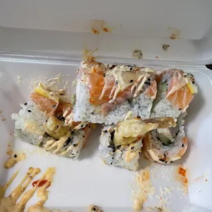 a sushi roll in a styrofoam container