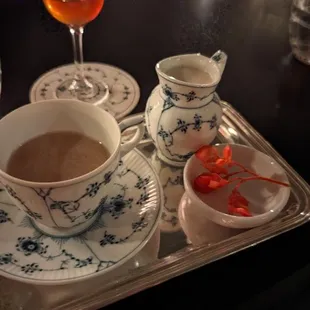 a cup of tea and saucer on a tray