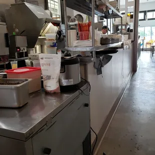 Open kitchen in hallway through restaurant