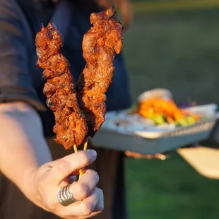 a person holding a plate of food