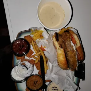 a plate of food including a sandwich, french fries, and dipping sauce