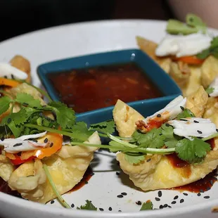 The Cheese Rangoon with Colossal Crab is made with colossal crab, pineapple sweet &amp; sour, chile, scallion, cilantro, &amp; fesno chile