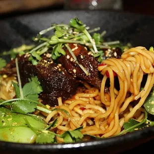 The Short Rib Spicy Noodles are made with lup cheong, garlic, ginger, scallion, baby bok-choy, blistered fesno chile, &amp; thai basil