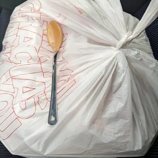 a plastic bag with a spoon in it