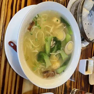 a bowl of soup on a wooden table