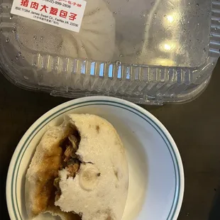 a half eaten baobob on a plate next to a plastic container