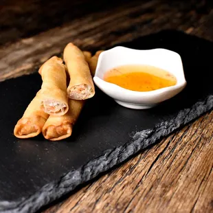 Lumpia Shanghai | Pork and veggies are wrapped in a lumpia wrapper and deep-fried. Comes with our house sweet &amp; spicy sauce.