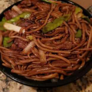 a plate of noodles and meat