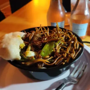 a bowl of noodles with meat and vegetables