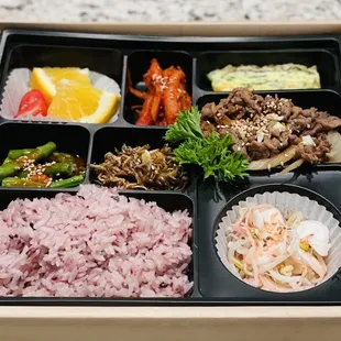Bento box with bulgogi and assortment of side dishes