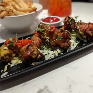 a platter of chicken wings and rice