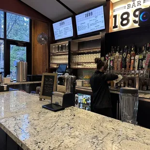 a man behind the counter at a bar
