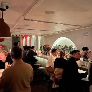 a group of people sitting at a bar