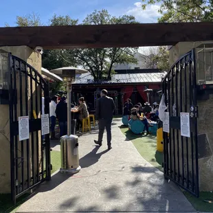 a man walking through a gated area