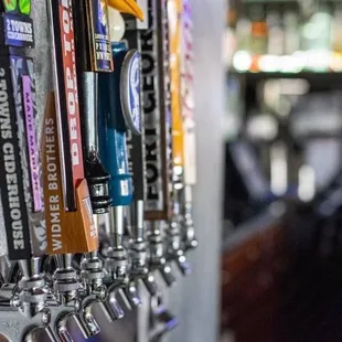 a row of beer taps in a bar