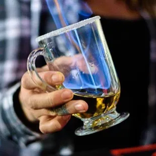 a person holding a glass of beer