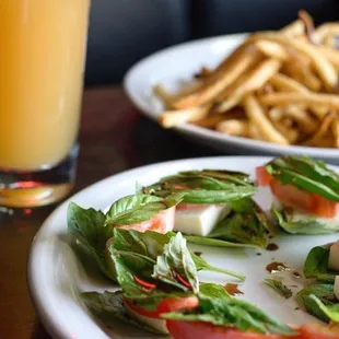 a plate of food and a glass of orange juice