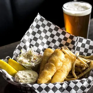 a basket of fish and chips and a beer