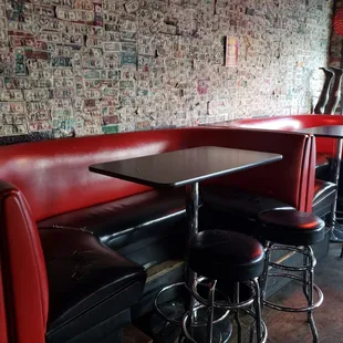 a red booth with black stools