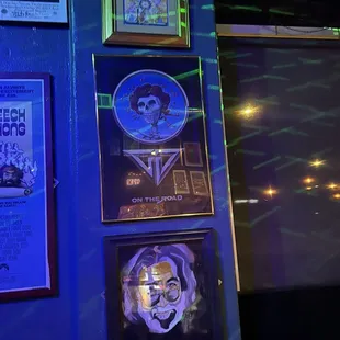 a blue wall with posters on it