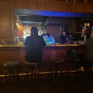 a group of people sitting at a bar