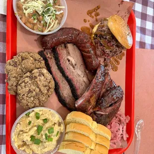 Chopped brisket sandwich, pork ribs, moist brisket, sausage, cheesy taters, pinto beans, and cookies