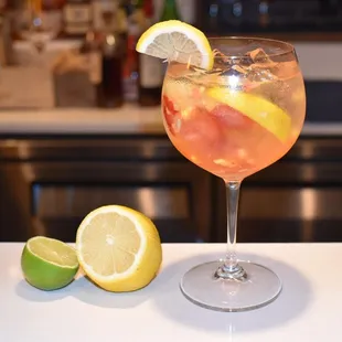 a glass of wine with a slice of lemon