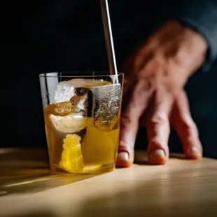 a glass of lemonade with a straw