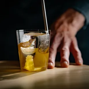 a glass of lemonade with a straw