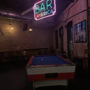 pool table and neon sign