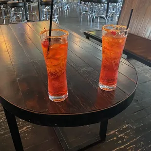 two cocktails on a wooden table
