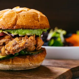 a chicken sandwich with pickles and cucumbers