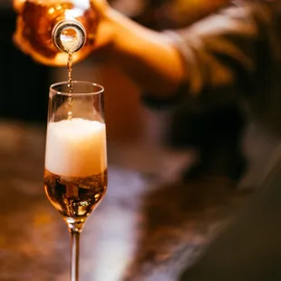 a person pouring a drink