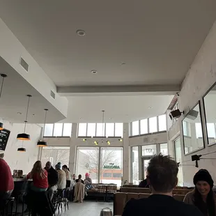 people sitting at tables in a restaurant
