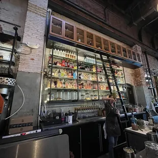 a man standing in front of the bar