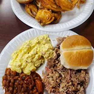 (Top) Hot Wings Plate with Onion Rings and Sweet Potato Fries (Bottom) Pulled Pork Plate with Baked Beans and Potato Salad