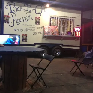 Eating on some cable spool makeshift tables. This is hardcore BBQ.