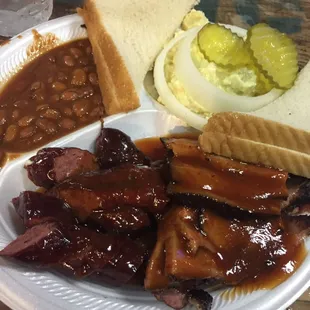 Sausage and brisket combo served with bread and butter, beans and potato salad. Very good!