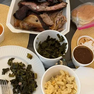 3 near plate with Ribs, Chicken, and Pulled Pork. Sides : mac and cheese and collard greens