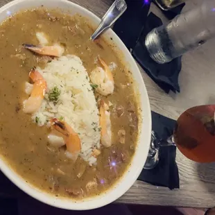 ows a bowl of soup with shrimp and rice