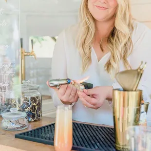 a woman holding a glass of juice