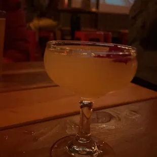 a cocktail in a glass on a wooden table