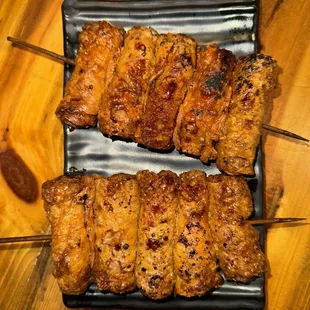 2 fried chicken skin skewers