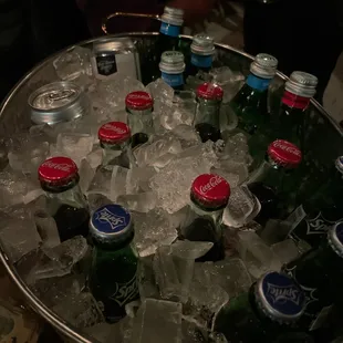 a bucket full of beer bottles