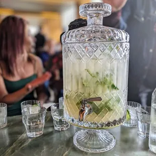 a large glass jar with a drink in it