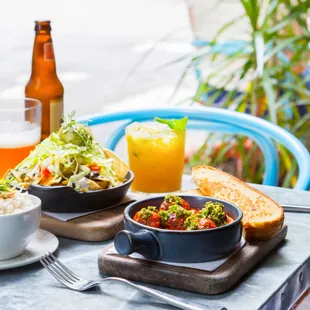 a plate of food and a glass of orange juice