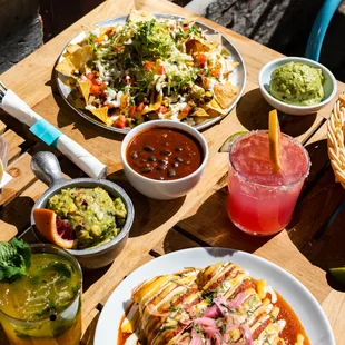 mexican food and drinks on a wooden table