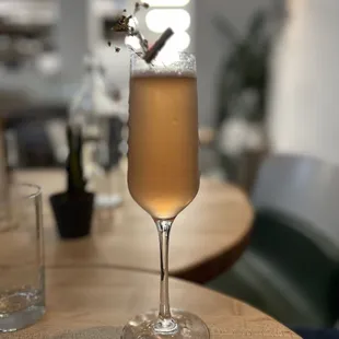 a glass of champagne on a table