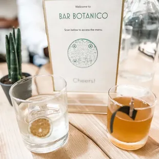 two glasses and a sign on a table